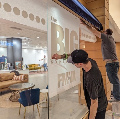 window vinyl sign installation at Fargo Moorhead Visual Arts 